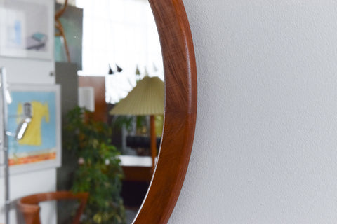 This beautifully modest 1960s teak mirror is the perfect piece to inject some retro charm to your home. The clean lines, simple round shape and rich wooden frame really give this mirror an effortless elegance which is sure to look lovely in any room of the house.&nbsp;

In nice condition for its age with the usual light surface wear commensurate with age including marks and dints to the frame.&nbsp;